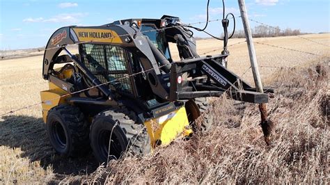 puting in post in a vineyard with a skid steer|skid steer fence posts.